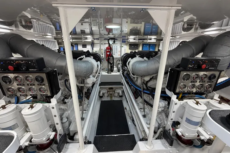 Defiance Yacht Photos Pics Engine room of a 2007 Viking 64 Convertible yacht, showcasing dual engines and control panels.