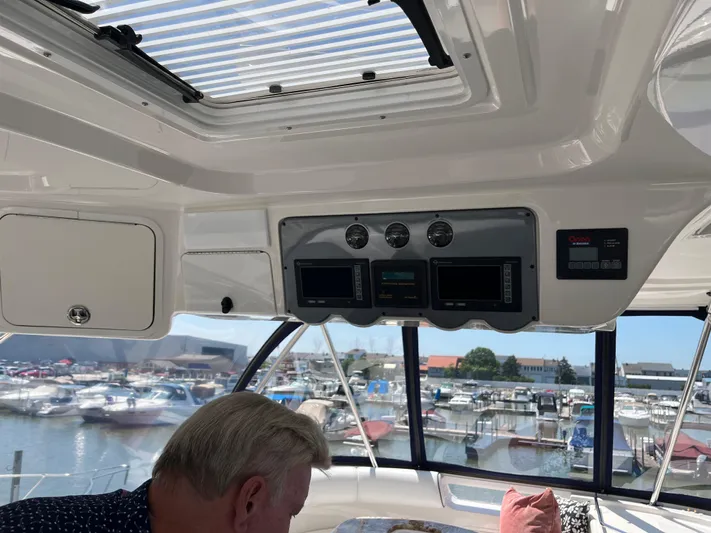  Yacht Photos Pics Interior view of 2008 Sea Ray 58 Sedan yacht with control panel and marina background.