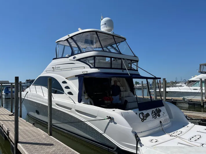  Yacht Photos Pics 2008 Sea Ray 58 Sedan yacht docked at marina under clear blue sky.