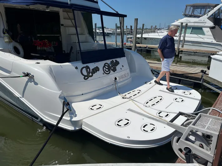  Yacht Photos Pics 2008 Sea Ray 58 Sedan yacht docked, man walking on deck, sunny marina setting.