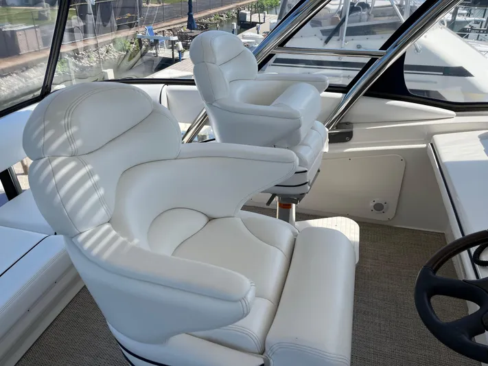  Yacht Photos Pics Luxurious white captain chairs on 2008 Sea Ray 58 Sedan yacht.