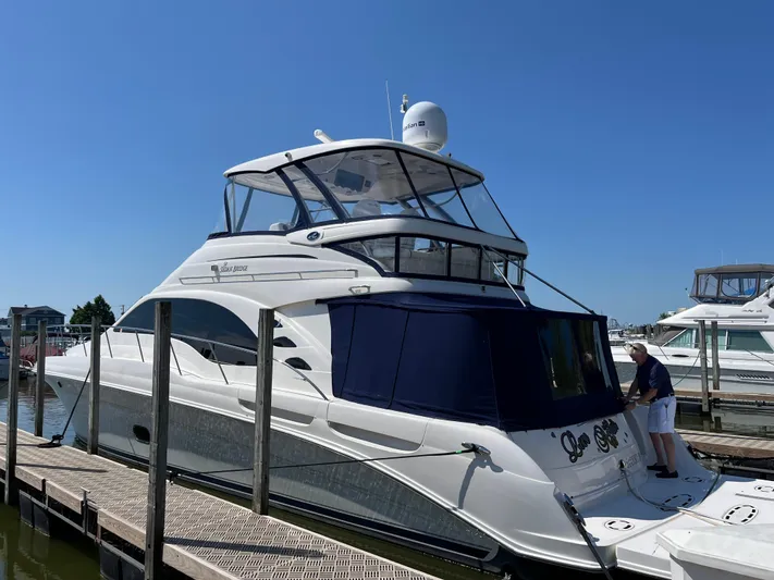  Yacht Photos Pics 2008 Sea Ray 58 Sedan yacht docked at marina under clear blue sky.