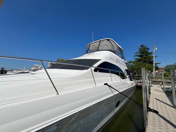  Yacht Photos Pics 2008 Sea Ray 58 Sedan yacht docked under clear blue sky.