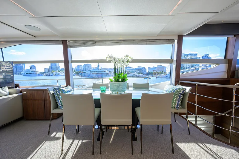 Janie II Yacht Photos Pics Luxurious interior of 2021 Princess Y78 yacht with waterfront view and elegant dining area.