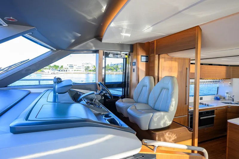 Janie II Yacht Photos Pics Luxurious interior of 2021 Princess Y78 yacht with modern helm and kitchen area.