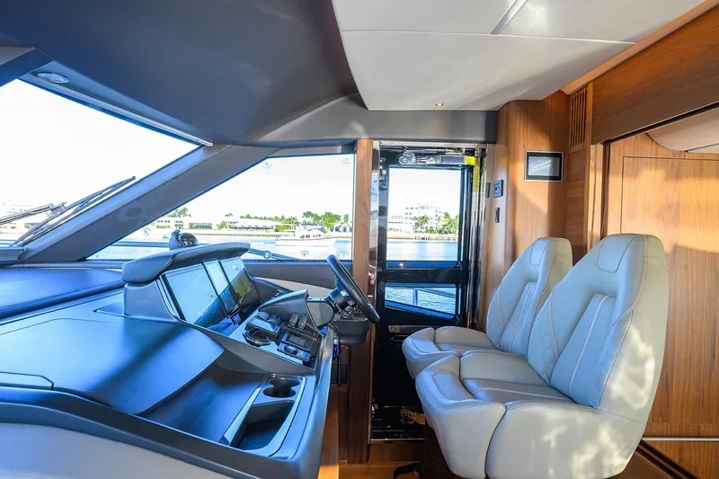Janie II Yacht Photos Pics Luxurious interior of 2021 Princess Y78 yacht with modern helm and plush seating.