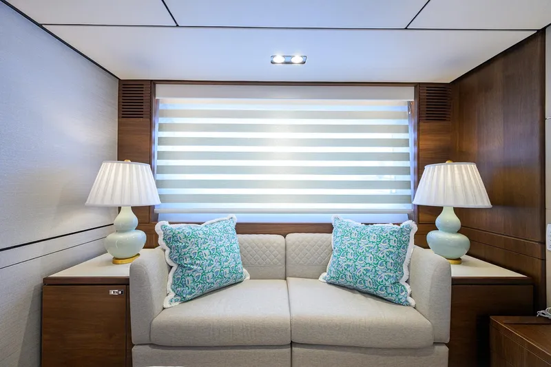 Janie II Yacht Photos Pics Luxurious interior of 2021 Princess Y78 yacht with elegant sofa and decorative pillows.