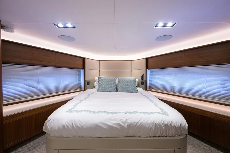 Janie II Yacht Photos Pics Luxurious bedroom interior of 2021 Princess Y78 yacht with elegant lighting and modern design.