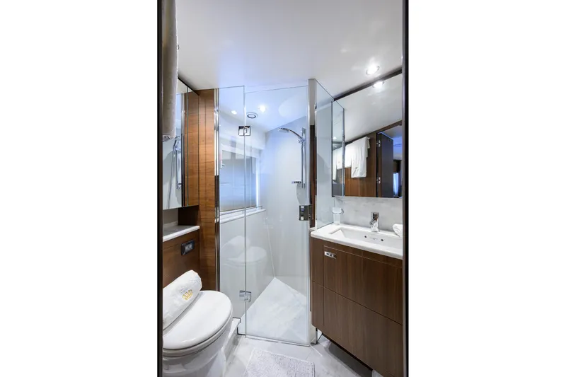 Janie II Yacht Photos Pics Luxurious bathroom in 2021 Princess Y78 yacht with modern fixtures and elegant wood accents.