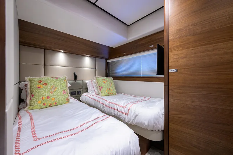 Janie II Yacht Photos Pics Luxurious twin bedroom in 2021 Princess Y78 yacht with elegant wood paneling.