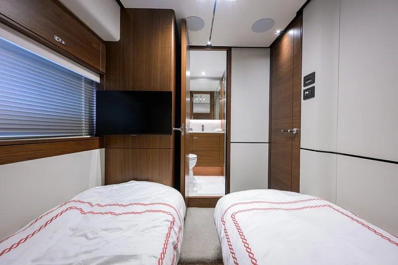 Janie II Yacht Photos Pics Interior of 2021 Princess Y78 yacht cabin with twin beds and ensuite bathroom.