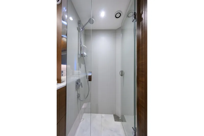 Janie II Yacht Photos Pics Luxurious shower in 2021 Princess Y78 yacht, featuring sleek glass doors and modern fixtures.