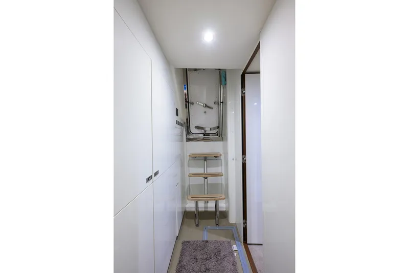 Janie II Yacht Photos Pics Interior of 2021 Princess Y78 yacht with sleek white cabinetry and compact ladder.
