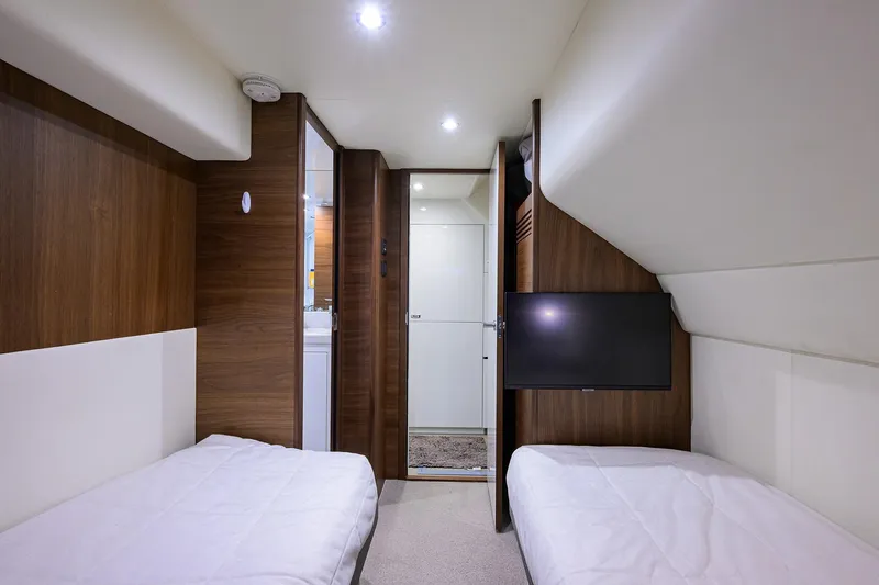 Janie II Yacht Photos Pics Luxurious interior of 2021 Princess Y78 yacht with twin beds and modern decor.