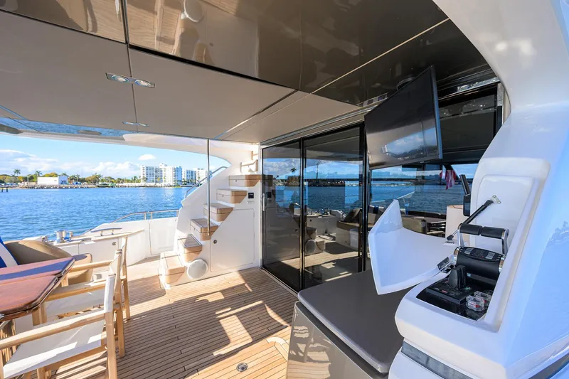 Janie II Yacht Photos Pics Luxurious 2021 Princess Y78 yacht deck with seating, stairs, and ocean view.