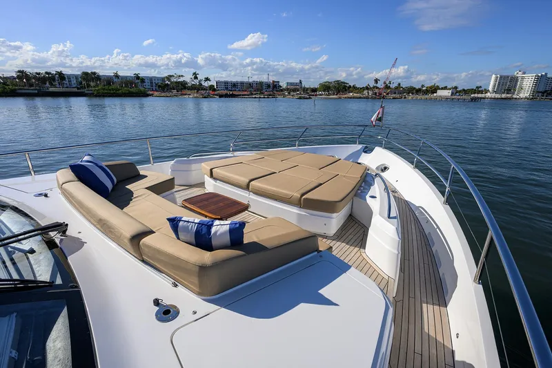 Janie II Yacht Photos Pics Luxurious 2021 Princess Y78 yacht deck with plush seating and scenic waterfront view.