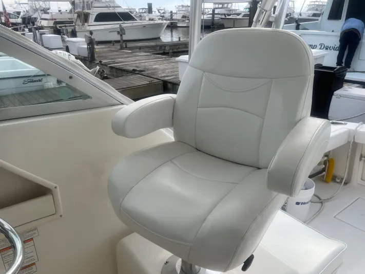  Yacht Photos Pics White captain's chair on 2008 Rampage 30 Express boat at marina.