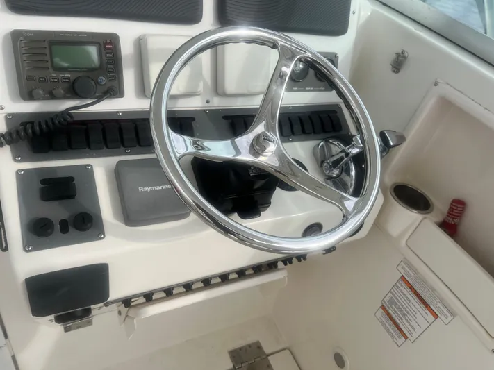  Yacht Photos Pics 2008 Rampage 30 Express boat helm with steering wheel and control panel.