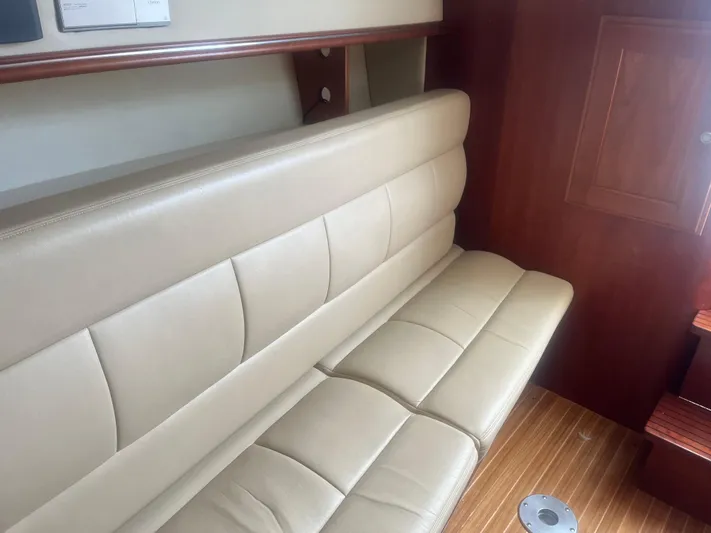  Yacht Photos Pics 2008 Rampage 30 Express interior with beige leather seating and wooden flooring.
