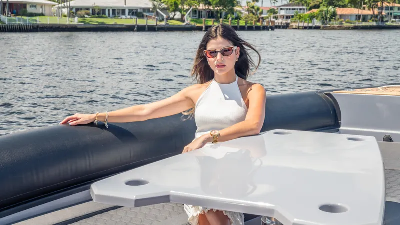 Skipper 38 Twin Mercury 400 V10 Verado Yacht Photos Pics Woman relaxing on a 2025 Skipper-BSK 38 boat, enjoying a sunny day on the water.