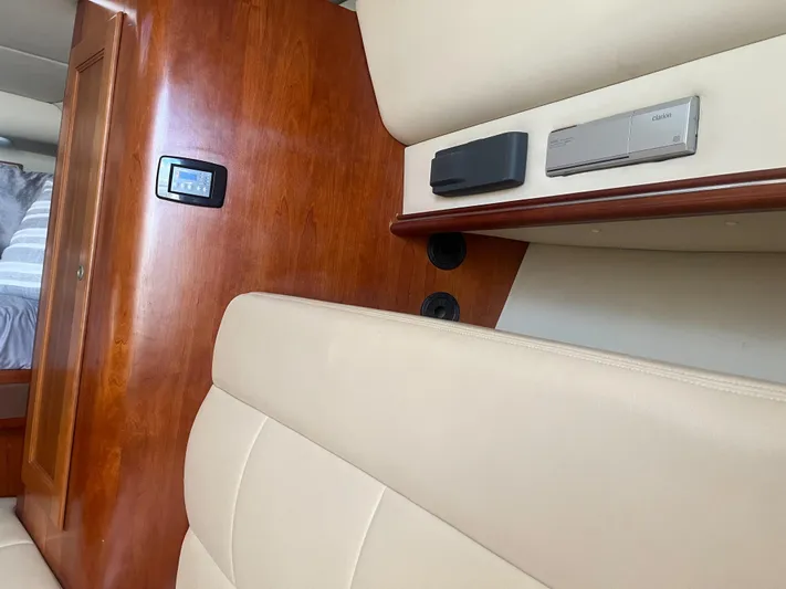  Yacht Photos Pics Interior of 2008 Rampage 30 Express with beige seating and wood paneling.