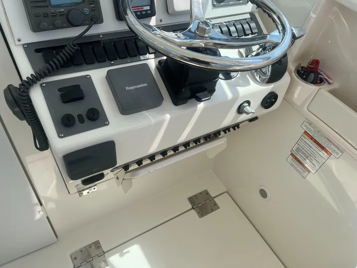  Yacht Photos Pics 2008 Rampage 30 Express boat helm with steering wheel and control panel.