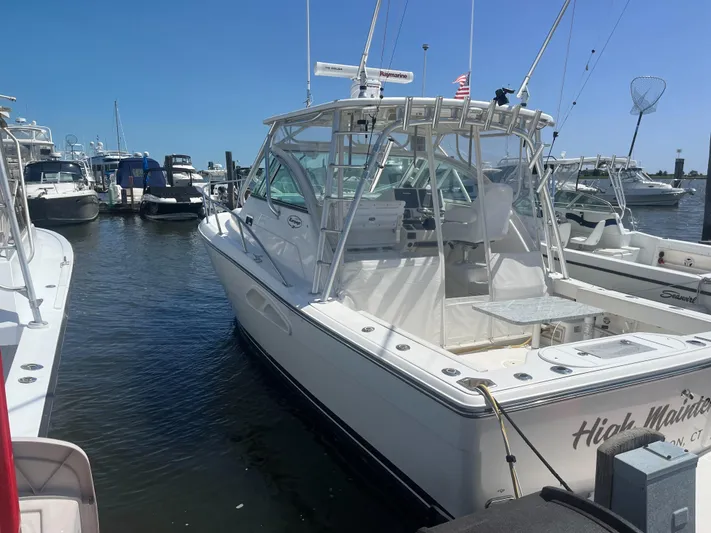  Yacht Photos Pics 2008 Rampage 30 Express boat docked in marina under clear blue sky.