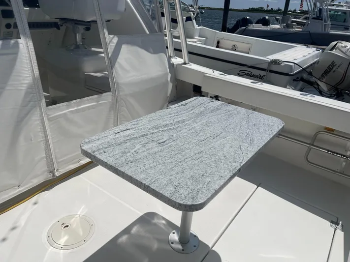  Yacht Photos Pics 2008 Rampage 30 Express boat with a sleek, modern deck table.