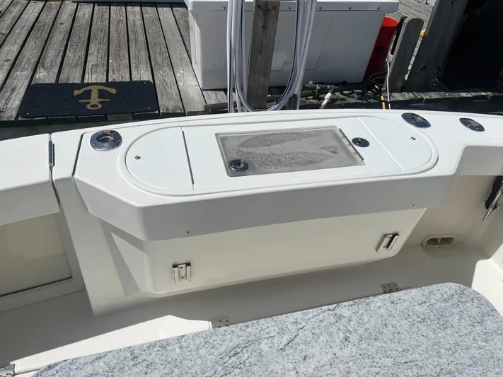  Yacht Photos Pics 2008 Rampage 30 Express boat deck with storage compartments and fishing rod holders.