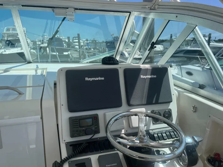  Yacht Photos Pics 2008 Rampage 30 Express boat helm with Raymarine navigation system.