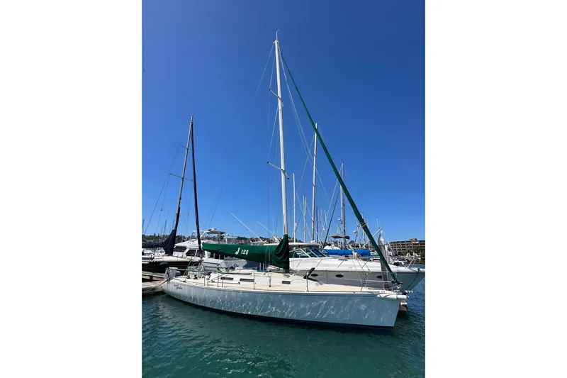 Ma Jolie Yacht Photos Pics 1996 J Boats J/120 sailboat docked in a marina under clear blue skies.