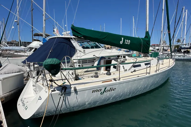 Ma Jolie Yacht Photos Pics 1996 J Boats J/120 sailboat docked in marina, featuring green sail cover.