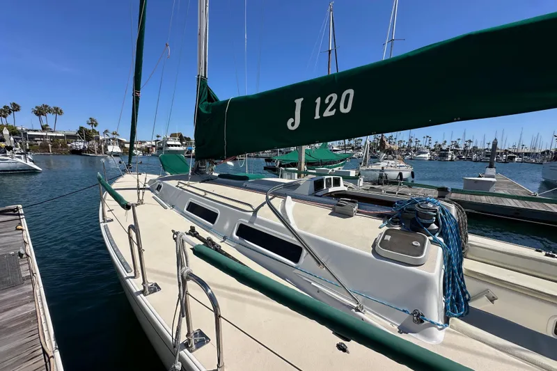 Ma Jolie Yacht Photos Pics 1996 J Boats J/120 sailboat docked in a marina under clear blue skies.