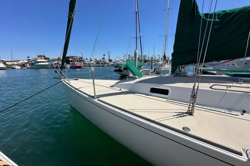 Ma Jolie Yacht Photos Pics 1996 J Boats J/120 sailboat docked in a marina under clear blue skies.