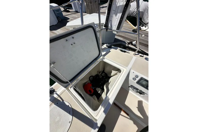 Ma Jolie Yacht Photos Pics Open storage compartment on 1996 J Boats J/120 sailboat deck, showing equipment inside.