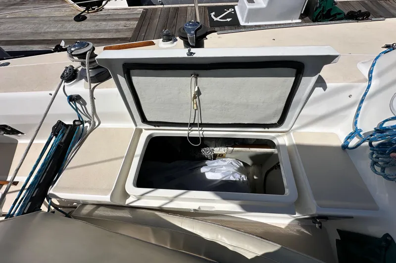 Ma Jolie Yacht Photos Pics Open storage compartment on 1996 J Boats J/120 sailboat deck, with ropes and winches visible.