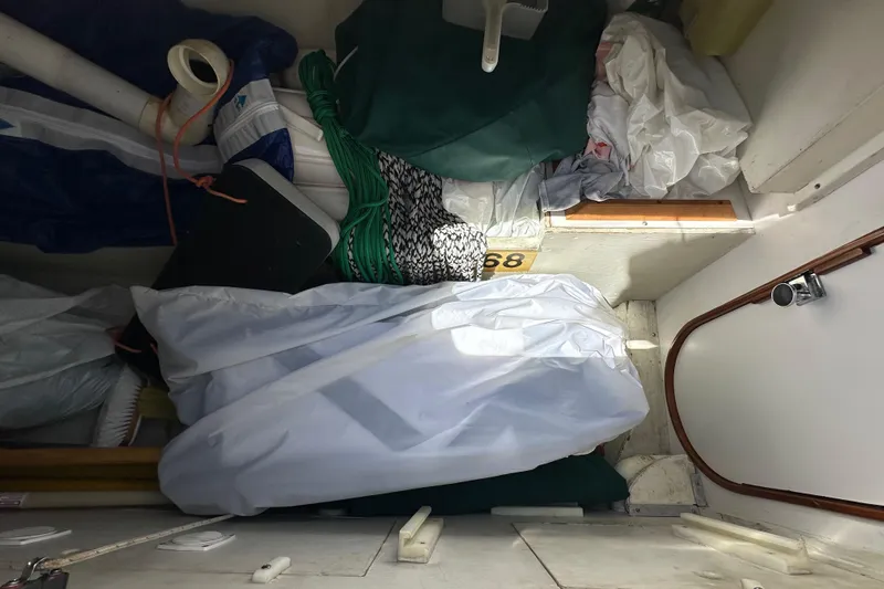 Ma Jolie Yacht Photos Pics Interior storage area of a 1996 J Boats J/120 sailboat with various equipment.