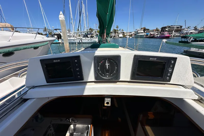 Ma Jolie Yacht Photos Pics 1996 J Boats J/120 cockpit with navigation instruments, docked in a marina.
