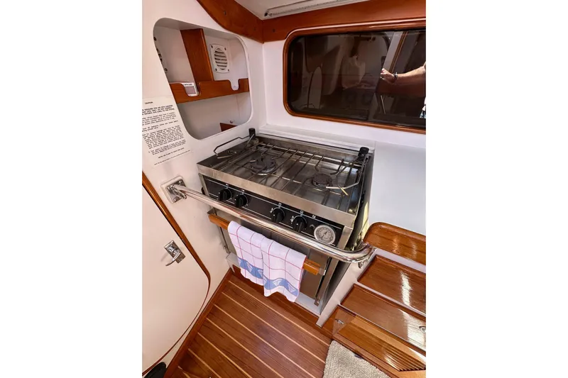 Ma Jolie Yacht Photos Pics 1996 J Boats J/120 yacht interior kitchen with stove and wooden flooring.