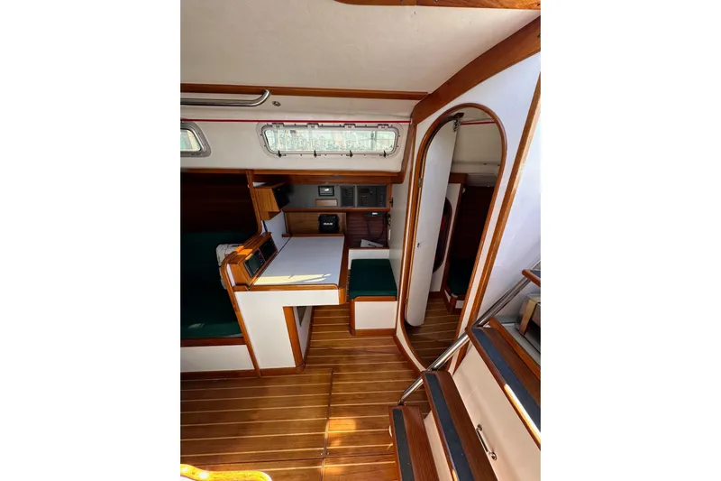 Ma Jolie Yacht Photos Pics 1996 J Boats J/120 interior with wood finish, compact dining area, and natural light.