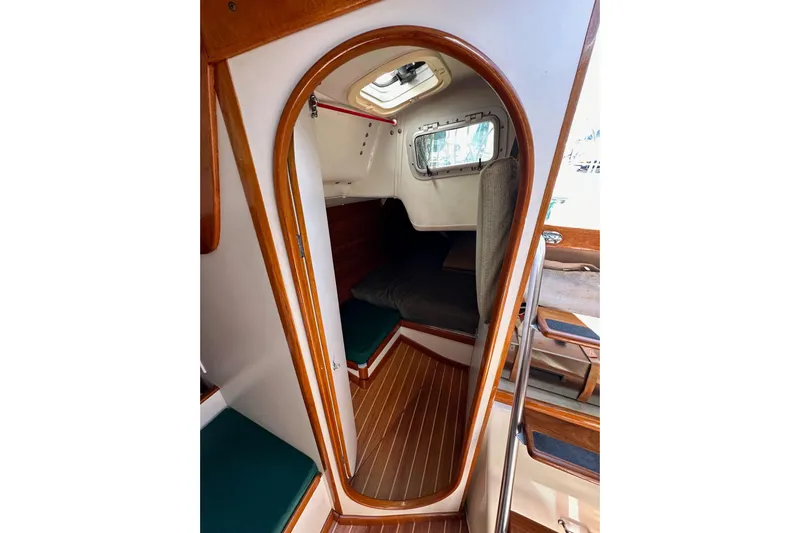 Ma Jolie Yacht Photos Pics Interior view of 1996 J Boats J/120 sailboat cabin with wooden trim and seating.