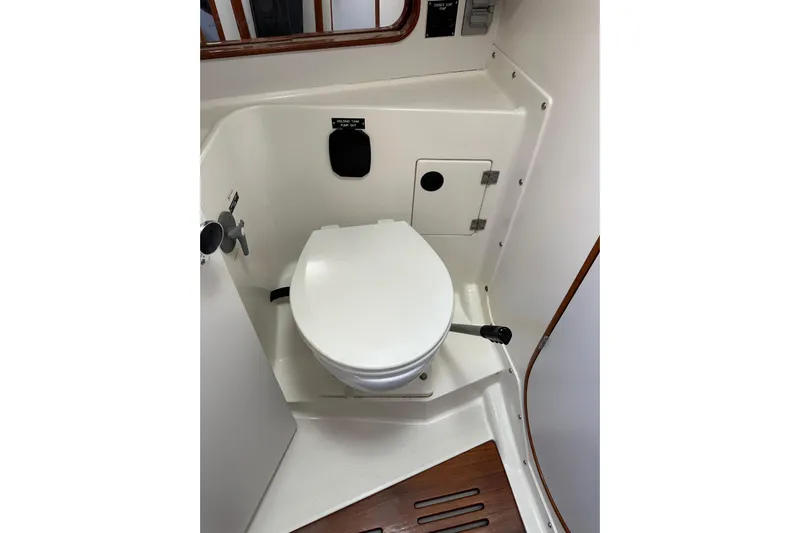 Ma Jolie Yacht Photos Pics 1996 J Boats J/120 yacht bathroom with white marine toilet and wooden floor accents.