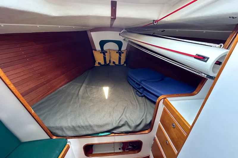 Ma Jolie Yacht Photos Pics Cozy cabin interior of 1996 J Boats J/120 with wooden paneling and storage.