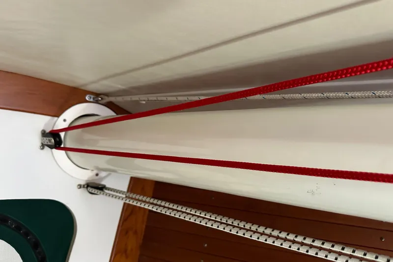 Ma Jolie Yacht Photos Pics Interior view of 1996 J Boats J/120 sailboat mast with red and white ropes.