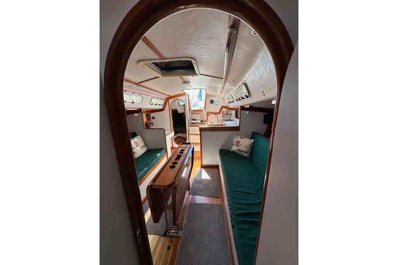 Ma Jolie Yacht Photos Pics Interior of 1996 J Boats J/120 sailboat with cozy seating and wooden accents.