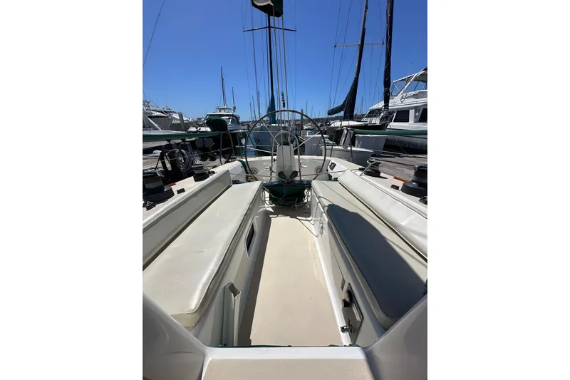 Ma Jolie Yacht Photos Pics 1996 J Boats J/120 sailboat cockpit with seating and steering wheel, docked at marina.