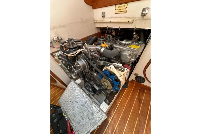 Ma Jolie Yacht Photos Pics Engine compartment of a 1996 J Boats J/120 sailboat, showcasing mechanical components.