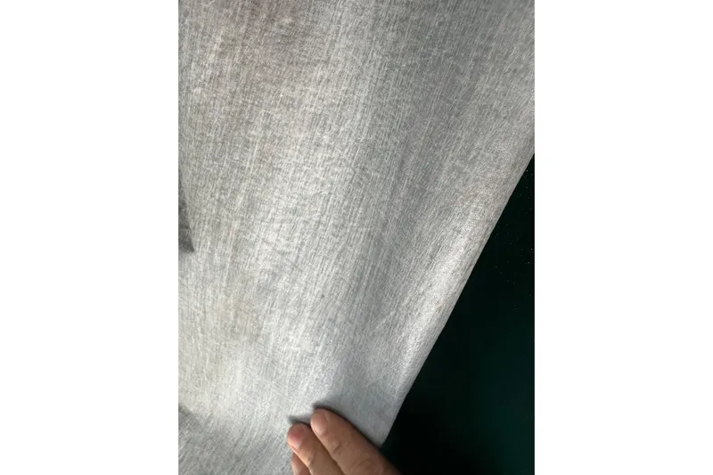 Ma Jolie Yacht Photos Pics Hand holding sailcloth from a 1996 J Boats J/120 yacht.