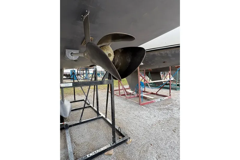 Knotaulis Yacht Photos Pics Propeller of 2023 Beneteau Oceanis 34.1 sailboat on a stand in a boatyard.
