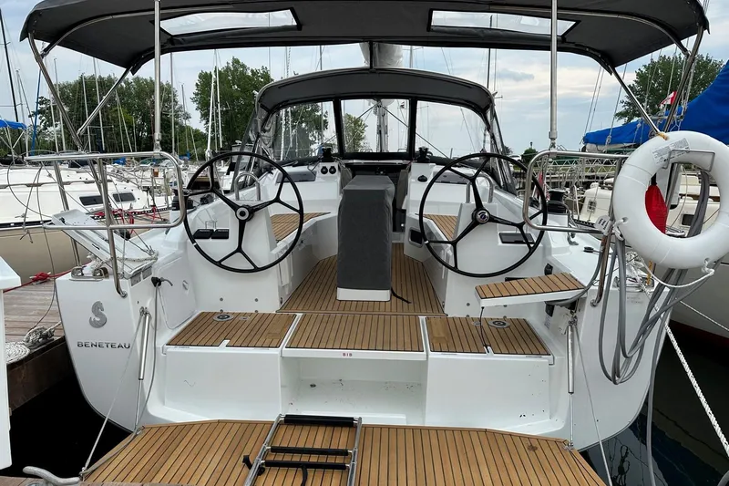 Knotaulis Yacht Photos Pics 2023 Beneteau Oceanis 34.1 sailboat cockpit with dual steering wheels and teak decking.